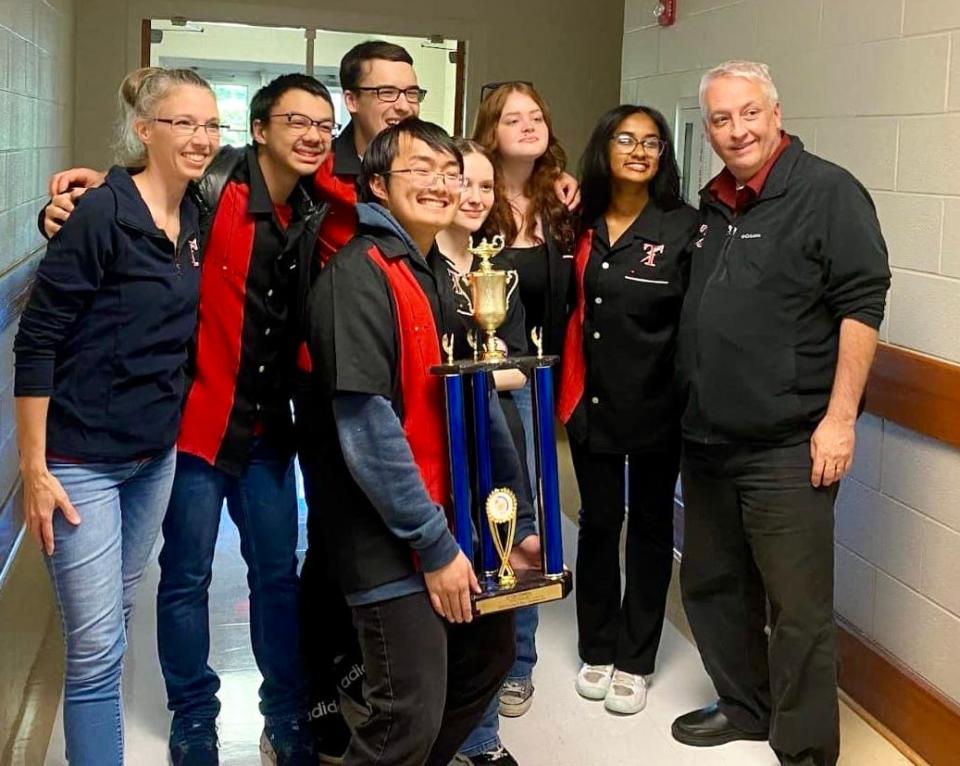 Gadsden City High School's varsity Scholars Bowl team won the Class 6A state championship April 12 at Jefferson State Community College's Shelby-Hoover Campus and will now advance to national competition over the Memorial Day weekend in New Orleans. From left are Assistant Coach Shila Miller, Corbin Ho, Alvinh Nguyen (with trophy), Chris Holder, Wren Gaines, Avery Clark, Latika Prasadh and Col. Wayne Davenport, the team's coach.