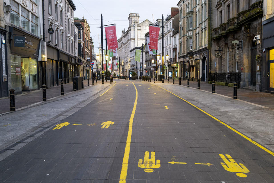 Deserted city street with handprint markings on the ground and banners hanging above