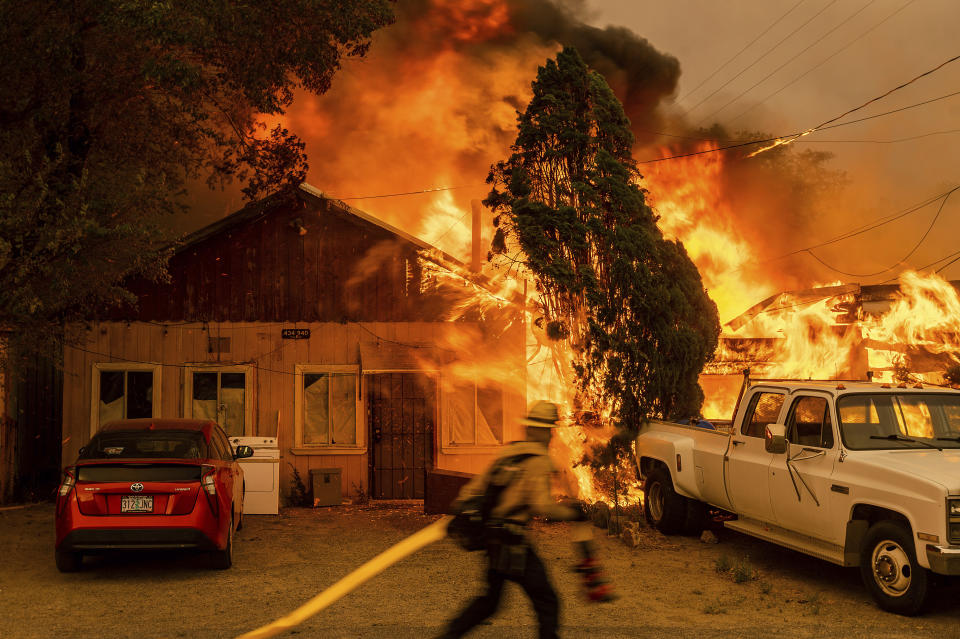 Fire consumes a home as the Sugar Fire, part of the Beckwourth Complex Fire, tears through Doyle, Calif., on Saturday, July 10, 2021. Pushed by heavy winds, the fire came out of the hills and destroyed multiple residences in central Doyle. (AP Photo/Noah Berger)