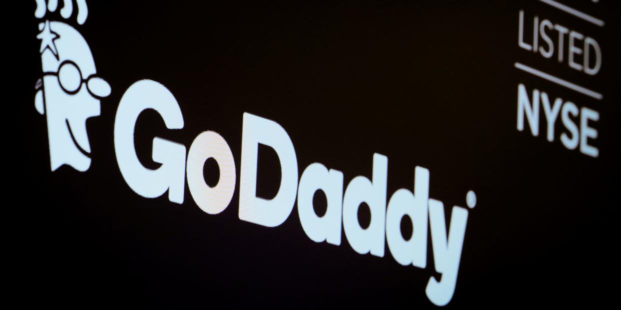 FILE PHOTO: The company logo and ticker for GoDaddy Inc. is displayed on a screen on the floor of the New York Stock Exchange (NYSE) in New York, U.S., March 4, 2019. REUTERS/Brendan McDermid