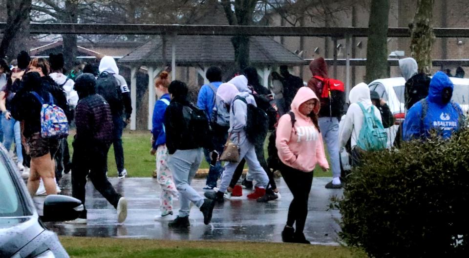 Riverdale students walk in the rain trying to avoid puddles as they hurry to change classes to and from the annex at Riverdale High School on Wednesday, March 22, 2023.