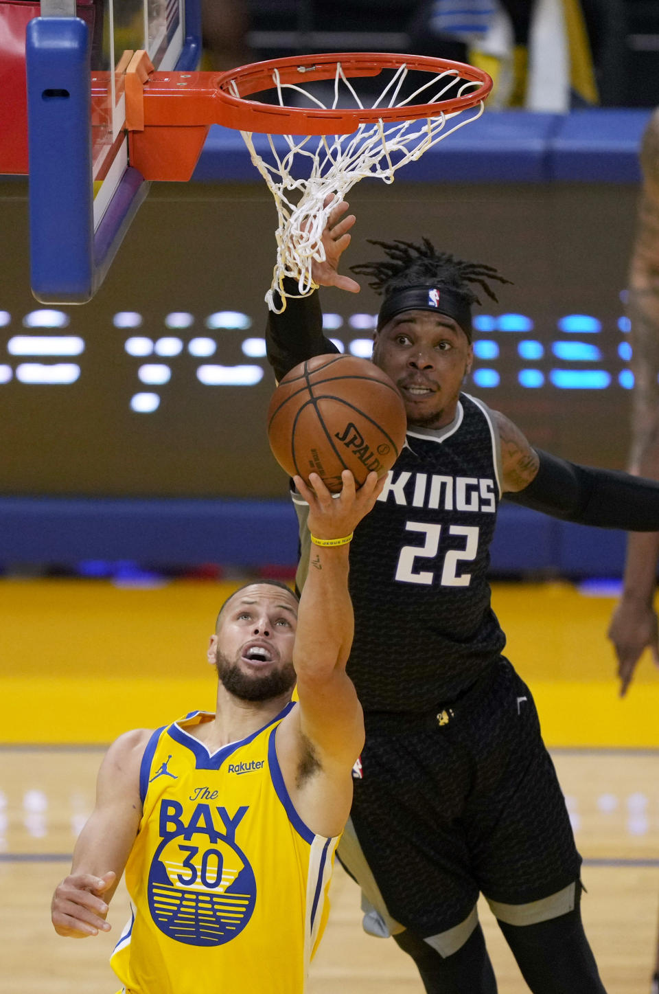 Golden State Warriors guard Stephen Curry (30) is blocked by Sacramento Kings center Richaun Holmes (22) during the first half of an NBA basketball game on Sunday, April 25, 2021, in San Francisco. (AP Photo/Tony Avelar)