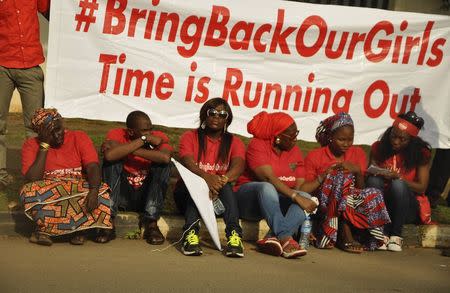 Members of the Abuja "Bring Back Our Girls" protest group sit during a protest march, in continuation of the Global Week of Action to commemorate six months since the abduction of the 219 Chibok school girls, organized by the group to the Presidential Villa, in Abuja October 14, 2014. REUTERS/Afolabi Sotunde