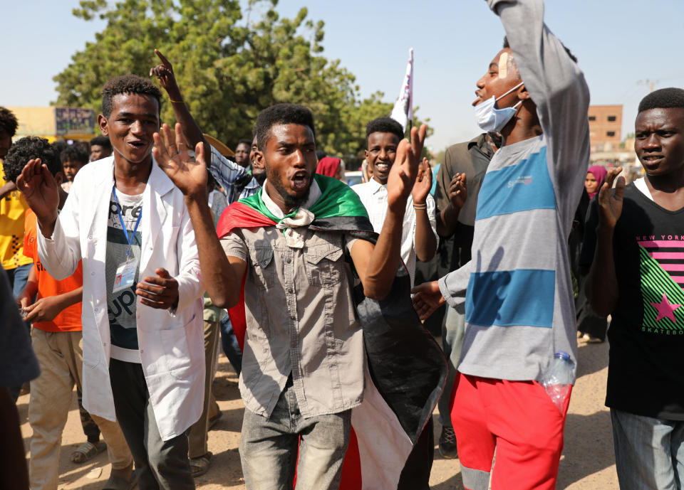 Protesters gather at a demonstration, in Khartoum, Sudan, Wednesday, Oct. 21, 2020. Protesters have taken to the streets in the capital and across the country over dire living conditions and a deadly crackdown on demonstrators in the east earlier this month. Sudan is currently ruled by a joint civilian-military government, following the popular uprising that toppled longtime autocrat Omar al-Bashir last year. (AP Photo/Marwan Ali)