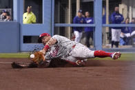 Philadelphia Phillies left fielder Kyle Schwarber can't get to a foul ball hit by Los Angeles Dodgers' Freddie Freeman during the third inning of a baseball game Friday, May 13, 2022, in Los Angeles. (AP Photo/Mark J. Terrill)