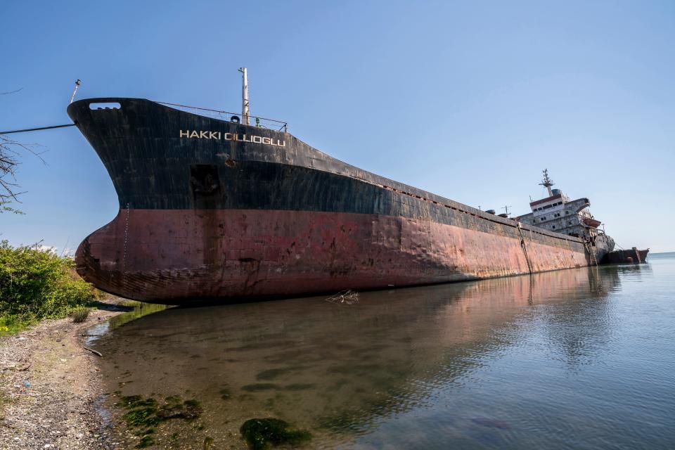 An abandoned cargo vessel lies