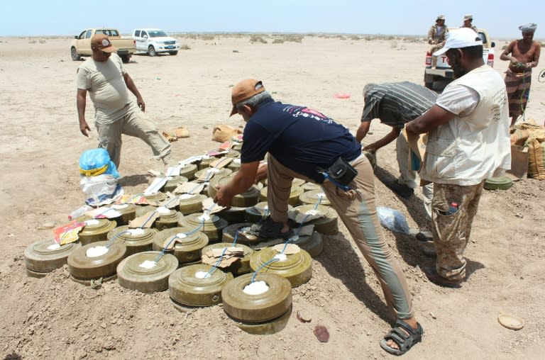 Yemeni security forces inspect unexploded ordnance confiscated from Al-Qaeda militants in the Lahj province