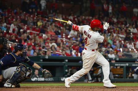 Apr 23, 2019; St. Louis, MO, USA; St. Louis Cardinals catcher Yadier Molina (4) hits a one run double off of Milwaukee Brewers relief pitcher Alex Wilson (not pictured) during the eighth inning at Busch Stadium. Mandatory Credit: Jeff Curry-USA TODAY Sports