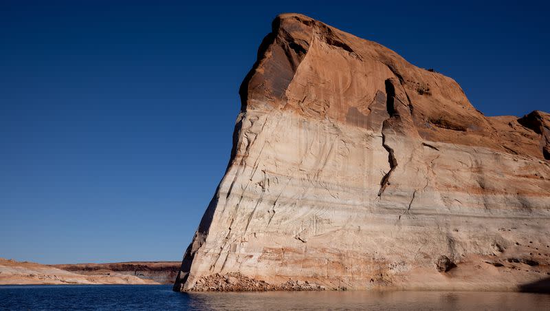 Lake Powell’s “bathtub ring,” a light-colored coating of mineral deposits left during periods of higher water on the reservoir, is seen on canyon walls on Thursday, Oct. 6, 2022 near Bullfrog. The Bullfrog North Boat Ramp has reached operable status for houseboats and other large vessels for the first time in months on Saturday.