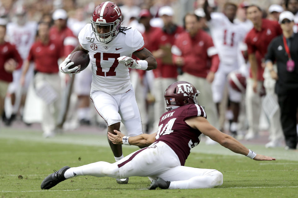 Alabama wide receiver Jaylen Waddle (17) jukes Texas A&M punter Braden Mann (34) during a punt return during the first half of an NCAA college football game, Saturday, Oct. 12, 2019, in College Station, Texas. (AP Photo/Sam Craft)