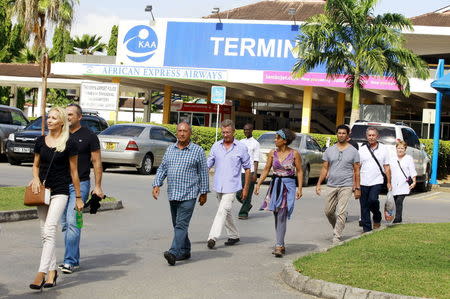 Passengers who were onboard an Air France Boeing 777 aircraft that made an emergency landing are escorted from Moi International Airport in Kenya's coastal city of Mombasa, December 20, 2015. REUTERS/Joseph Okanga