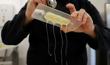 Nestle's Jan Kuendiger removes excess white chocolate from a mould in a kitchen at the company's Product Technology Centre in York, Britain, March 21, 2018. REUTERS/Phil Noble