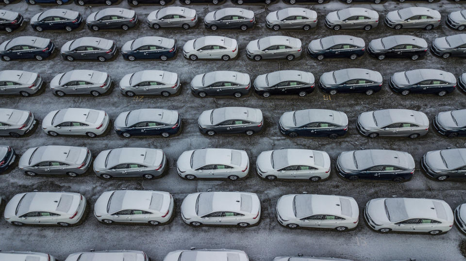 FILE - In this Dec. 5, 2018 file photo, hundreds of Chevrolet Cruze cars sit in a parking lot at General Motors' assembly plant in Lordstown, Ohio. The long-struggling Rust Belt community of Youngstown, Ohio, which was stung by the loss of the massive General Motors Lordstown plant this year, wants to become a research and production hub for electric vehicles.. But Youngstown faces competition from places like Detroit and China that are taking big roles in developing electric vehicles. (Andrew Rush/Pittsburgh Post-Gazette via AP, File)