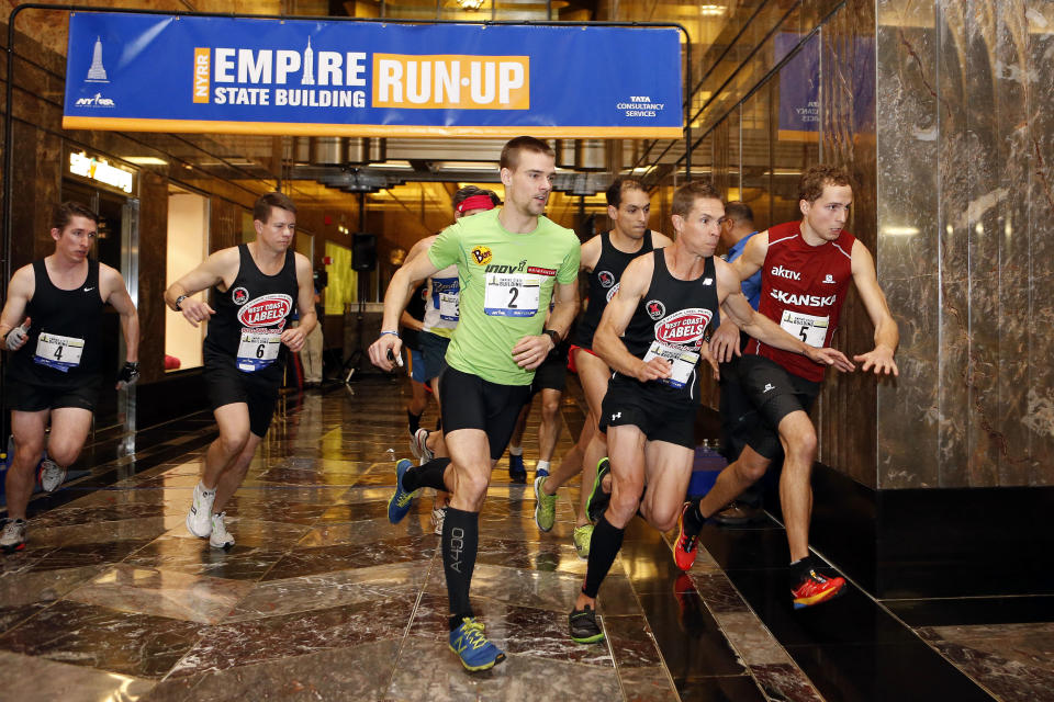 Slovakia's Tomas Celko (2), Australia's Darren Wilson, second from right, and Norway's Thorbjorn Ludvigsen (5) lead the men's division as they sprint for the stairs at the start of the Empire State Building Run-Up on Wednesday, Feb. 5, 2014, in New York. Ludvigsen won the race. (AP Photo/Jason DeCrow)