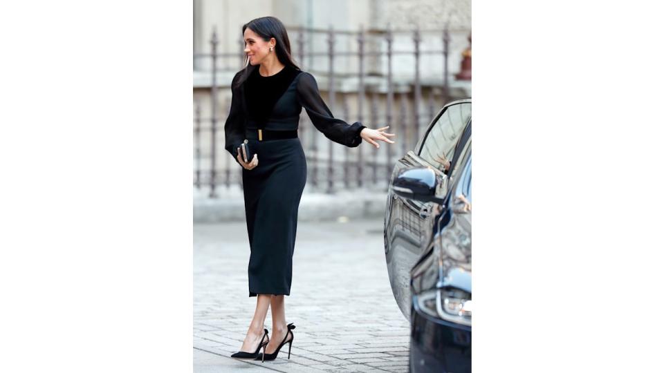 Meghan Markle closing car door in black dress