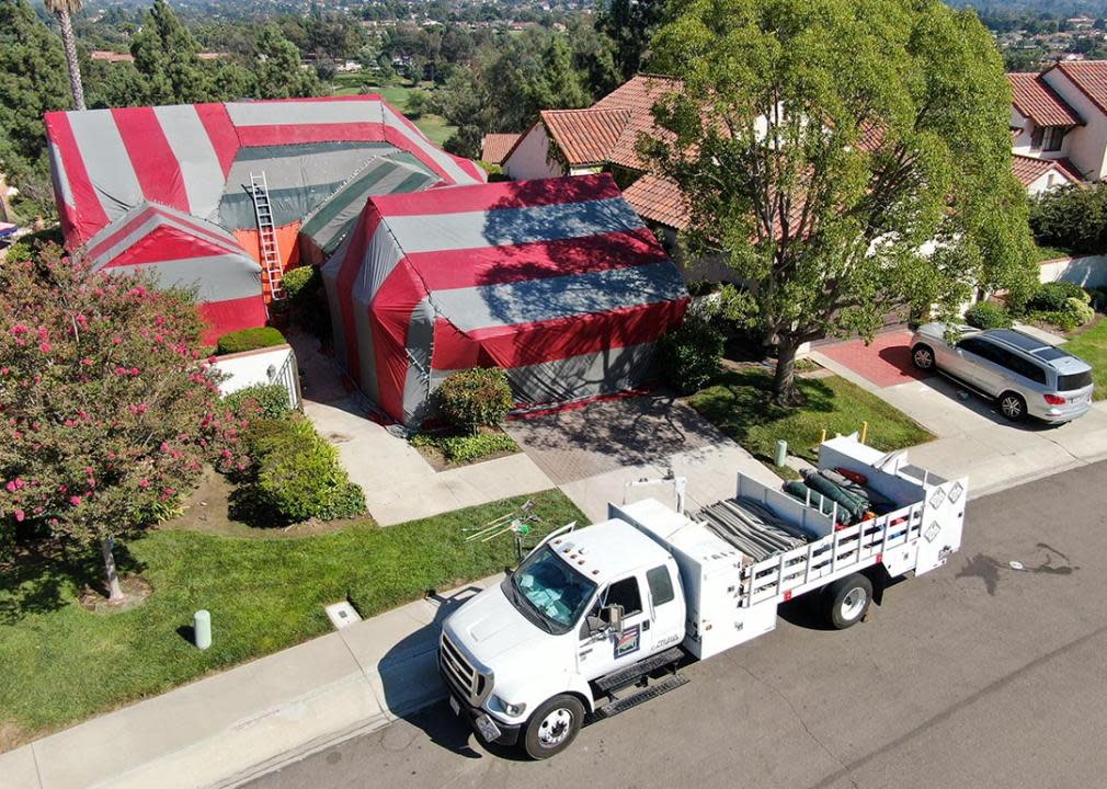 red and green tent covering home being fumigated