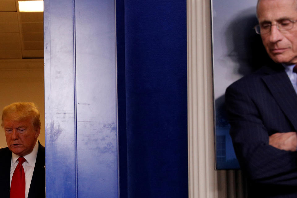 U.S. President Donald Trump arrives behind Dr. Anthony Fauci, Director of the National Institute of Allergy and Infectious Diseases, for the start of the daily coronavirus response briefing press briefing room of the White House in Washington, U.S., March 31, 2020. REUTERS/Tom Brenner     TPX IMAGES OF THE DAY