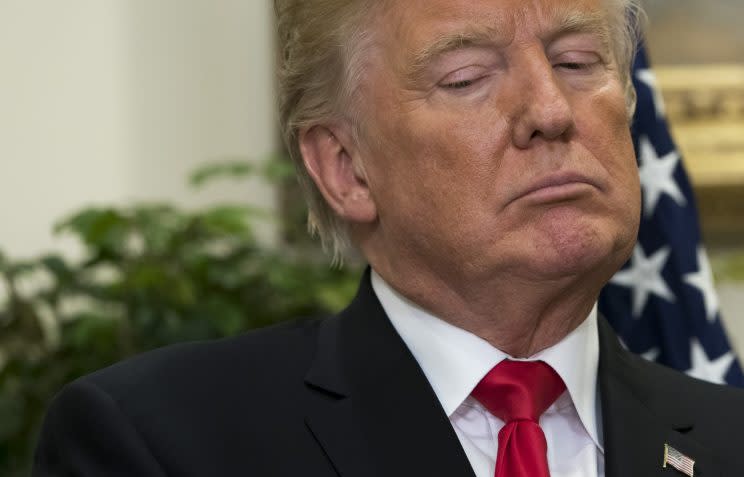 U.S. President Donald Trump looks on during the announcement of a a newly designed, Made in America pharmaceutical glass bottle jointly developed by Merck, Pfizer and Corning during a Made in America Week event in the Roosevelt Room of the White House in Washington, DC, July 20, 2017. (