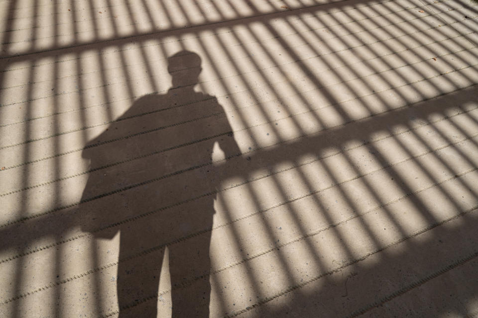 shadow of a person with a bag