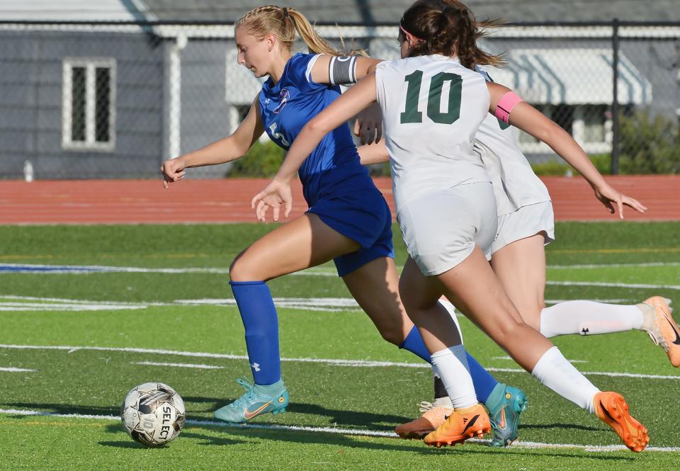 Fort LeBoeuf High School senior Emily Samluk, left, slips between two Mercyhurst Prep defenders, including senior Naomi Warshaw (10) during a girls soccer match in Waterford on Aug. 29.