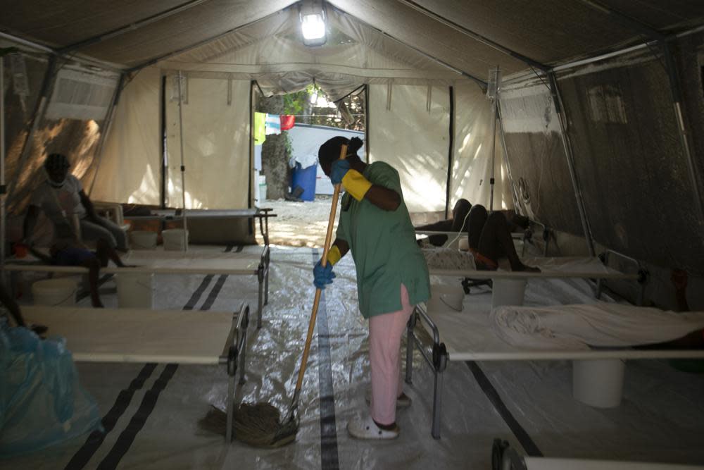 A hospital worker cleans inside a tent where people suffering cholera symptoms are treated at a clinic run by Doctors Without Borders in Port-au-Prince, Haiti, Friday, Oct. 7, 2022. The World Health Organization and partners are recommending that countries temporarily switch to using a single dose of the cholera vaccine _ instead of two _ due to a global vaccine shortage as outbreaks of the water-borne disease surge globally. (AP Photo/Odelyn Joseph, File)