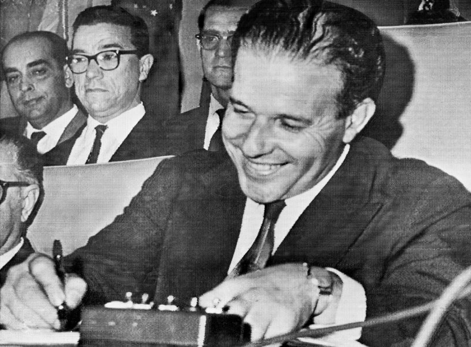 FILE - In this Sept. 8, 1961 file photo, Brazil's President-elect Joao Goulart signs papers to assume office at Congress in Brasilia, Brazil. In 1964, leftist President Joao Goulart of Brazil was overthrown in a U.S.-backed coup that installed a military government lasting until the 1980s. (AP Photo, File)