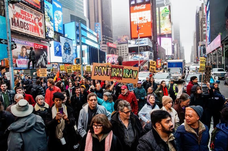 People take part in an anti-war protest amid increased tensions between the United States and Iran at Times Square in New York
