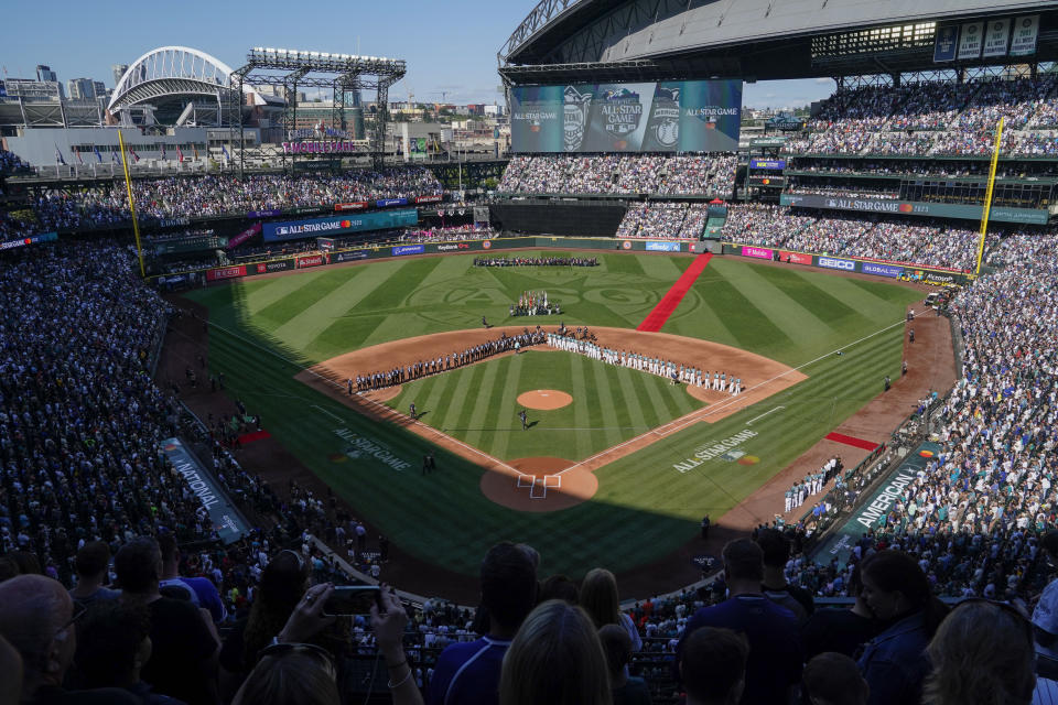 The All-Star Game logo is seen on the field at T-Mobile Park during the national anthem before the baseball game in Seattle, Tuesday, July 11, 2023. (AP Photo/Ted S. Warren)