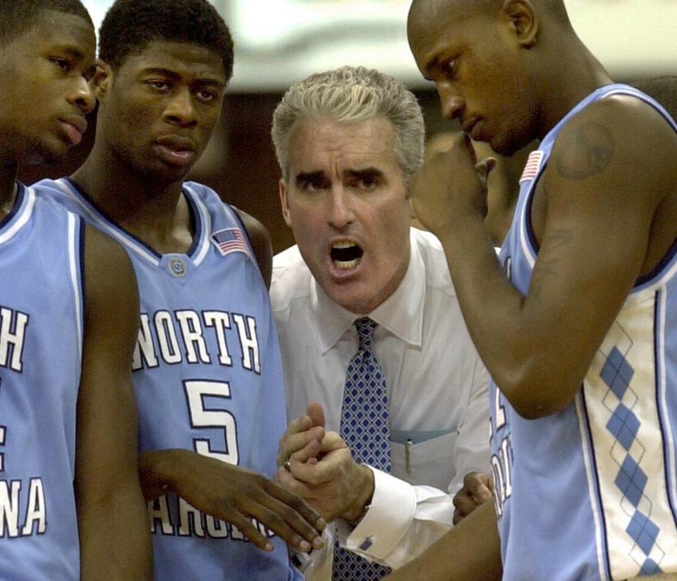 Matt Doherty (center) was UNC’s head basketball coach from 2000-2003 before being forced to resign after a stormy tenure. He has written a new leadership book called “Rebound” that details those years.