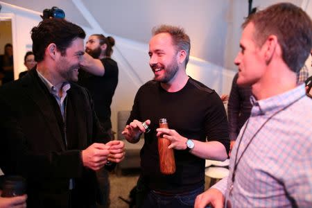 Drew Houston (2nd L), Chief Executive Officer and founder of Dropbox, converses following the cloud storage company's announcement event in San Francisco, California, U.S., January 30, 2017. REUTERS/Beck Diefenbach - RTX2YW3V