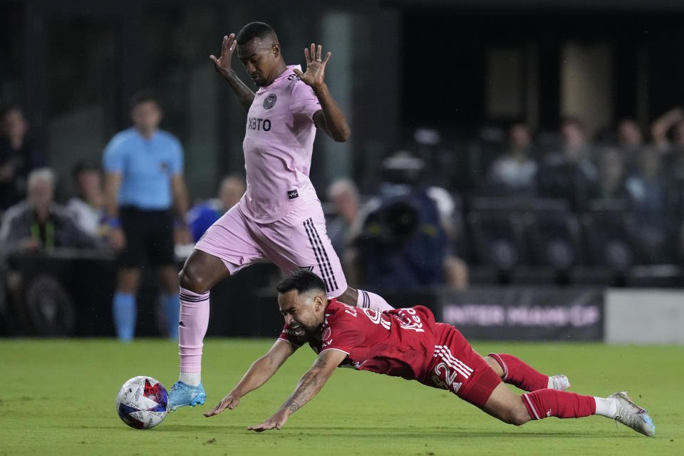 New York Red Bulls forward Luquinhas falls as he clashes with Inter Miami midfielder Dixon Arroyo during the first half of an MLS soccer match Wednesday, May 31, 2023, in Fort Lauderdale, Fla. (AP Photo/Rebecca Blackwell)