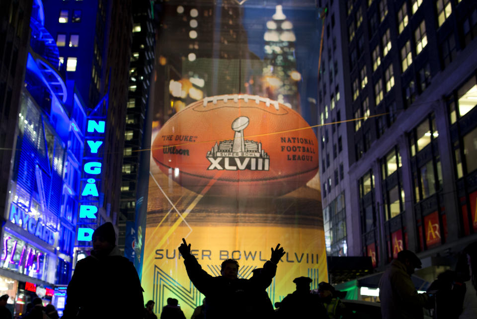 Fans gather on the Super Bowl Boulevard in Times Square on Friday, Jan. 31, 2014, in New York. The Seattle Seahawks will play the Denver Broncos on Sunday in NFL football's Super Bowl XLVIII in East Rutherford, N.J. (AP Photo/ Evan Vucci)