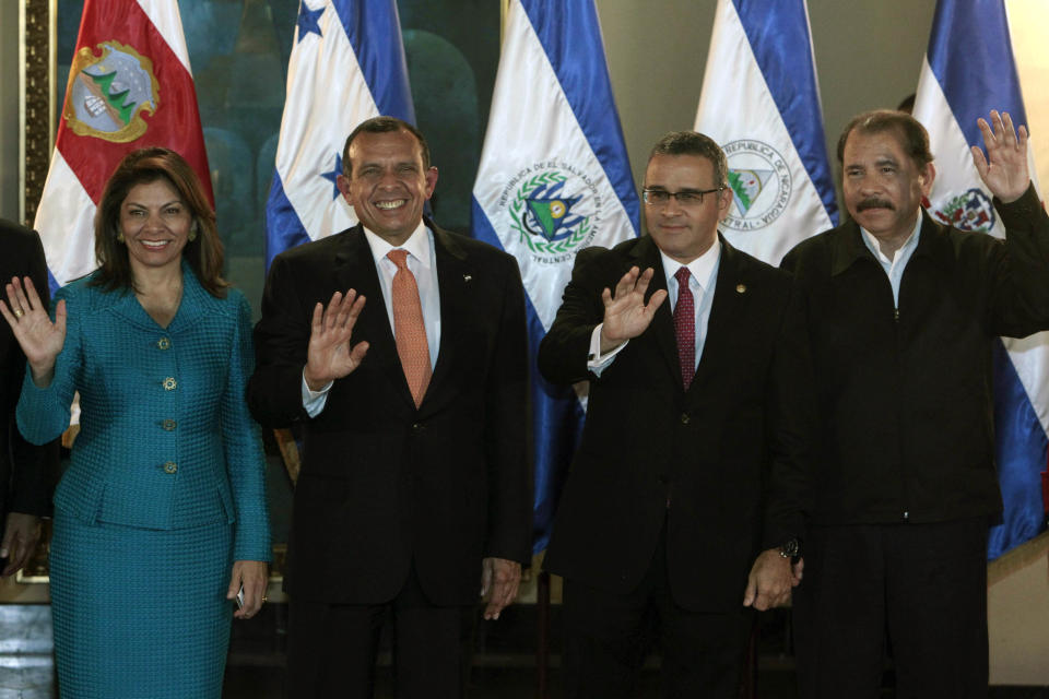 Authorities, from left to right, Costa Rica's President Laura Chichilla, Honduras's President Porfirio Lobo, El Salvador's President Mauricio Funes and Nicaragua's President Daniel Ortega wave to media members after meeting U.S. Vice President Joe Biden at the presidential house in Tegucigalpa, Honduras, Tuesday, March 6, 2012. Biden is on a one-day visit to Honduras. (AP Photo/Esteban Felix)