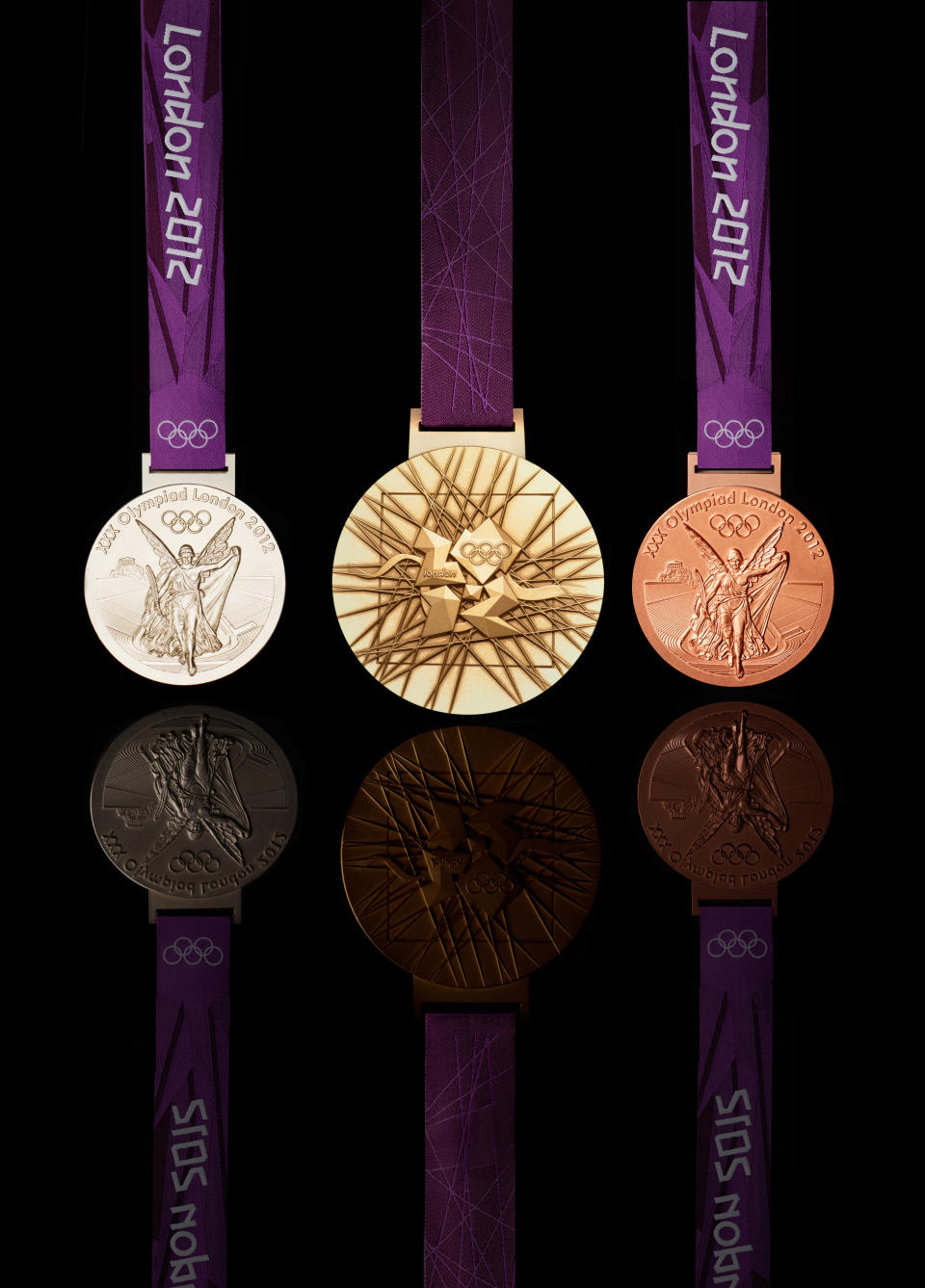 LONDON, UNITED KINGDOM -JULY 27: This handout image supplied by The London Organising Committee of the Olympic and Paralympic Games (LOCOG), shows the medals that will be awarded in the London 2012 Olympic Games, designed by British artist David Watkins. The medal depicts 'Nike', the Greek Goddess of Sport, stepping out of a scene depicting of the Parthenon and Panathinaiko Stadium. The one year countdown to the London 2012 Olympic games was marked with a unique ceremony in Trafalgar Square, with IOC President Jacques Rogge inviting the world's athletes to compete in next summer's games. (Photo by LOCOG via Getty Images)