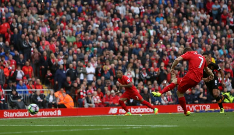Liverpool's English midfielder James Milner shoots from the penalty spot to score his team's fifth goal against Hull City in Liverpool