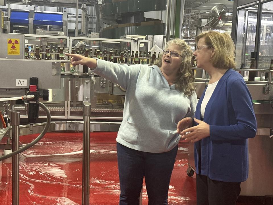 Wisconsin Democratic U.S. Sen. Tammy Baldwin talks to New Glarus Brewing Company co-owner Deb Carey during a campaign stop Thursday, March 28, 2024, in New Glarus, Wis. The stop was part of her campaign launch tour in a race against Republican Eric Hovde the could determine who has majority control of the Senate. The Wisconsin Senate race between Democratic Sen. Tammy Baldwin and Republican Eric Hovde is setting up as one of the most competitive and expensive Senate races in the country. (AP Photo/Scott Bauer)