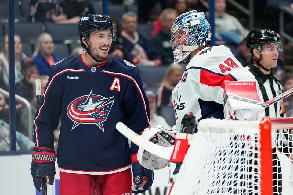 Sep 30, 2024; Columbus, Ohio, USA; Columbus Blue Jackets defenseman Zach Werenski (8) talks to Washington Capitals goaltender Logan Thompson (48) during the third period of the NHL hockey game at Nationwide Arena. The Blue Jackets lost 3-2.