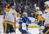 Nashville Predators' Luke Evangelista, left, and Ryan O'Reilly (90) celebrate O'Reilly's goal against the Vancouver Canucks during the second period in Game 1 of an NHL hockey Stanley Cup first-round playoff series in Vancouver, British Columbia, on Sunday, April 21, 2024. (Darryl Dyck/The Canadian Press via AP)