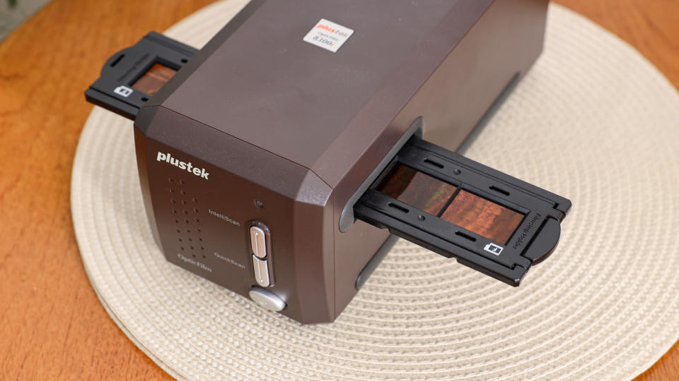 Plustek OpticFilm 35mm film scanner on a wooden table