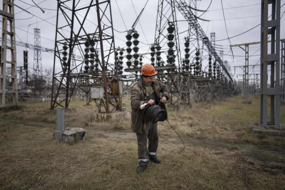 A worker at a power plant, tries to repair damages after a Russian attack in central Ukraine, Thursday, Jan. 5, 2023. When Ukraine was at peace, its energy workers were largely unheralded. War made them heroes. They're proving to be Ukraine's line of defense against repeated Russian missile and drone strikes targeting the energy grid and inflicting the misery of blackouts in winter. (AP Photo/Evgeniy Maloletka)
