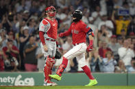 Boston Red Sox's Enrique Hernandez, right, arrives at home after hitting a home run, next to Cincinnati Reds' Curt Casali during the seventh inning of a baseball game, Thursday, June 1, 2023, in Boston. (AP Photo/Steven Senne)