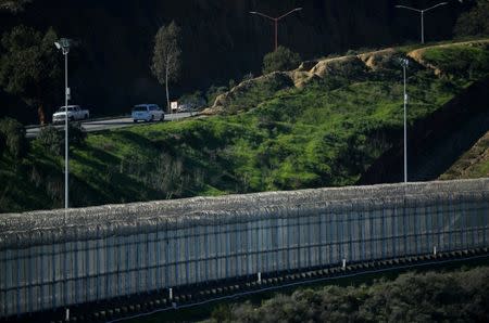 Traffic in Tijuana, Mexico is shown next to border fencing separating the United States and Mexico in San Ysidro, California, U.S., January 25, 2017. REUTERS/Mike Blake