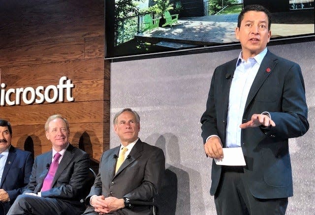 Ricardo Mora, CEO of the Juarez Technology Hub, talks about Microsoft's $1.5 million investment in the new Bridge Accelerator program. Texas Gov. Greg Abbott, Microsoft President Brad Smith, center, and Chihuahua Gov. Javier Corral listen.