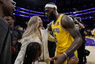 Los Angeles Lakers forward LeBron James celebrates with his wife Savannah and daughter Zhuri after passing Kareem Abdul-Jabbar to become the NBA's all-time leading scorer during the second half of an NBA basketball game against the Oklahoma City Thunder Tuesday, Feb. 7, 2023, in Los Angeles.(AP Photo/Ashley Landis)