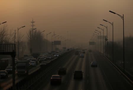 Vehicles drive on the 5th Ring Road in smog during morning rush hour on the fourth day after a red alert was issued for heavy air pollution in Beijing, China, December 19, 2016. REUTERS/Jason Lee