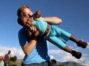 <p>Harry plays with a young boy during a visit to the Phelisanong Children's Home in 2014.</p>