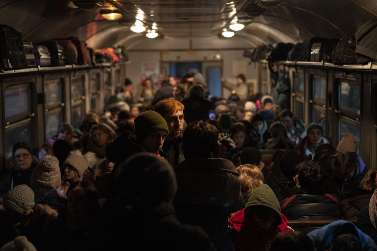 Displaced Ukrainians onboard a Poland bound train in Lviv, western Ukraine, Sunday, March 13, 2022. Lviv in western Ukraine itself so far has been spared the scale of destruction unfolding to its east and south. The city's population of 721,000 has swelled during the war with residents escaping bombarded population centers and as a waystation for the nearly 2.6 million people who have fled the country. (AP Photo/Bernat Armangue)