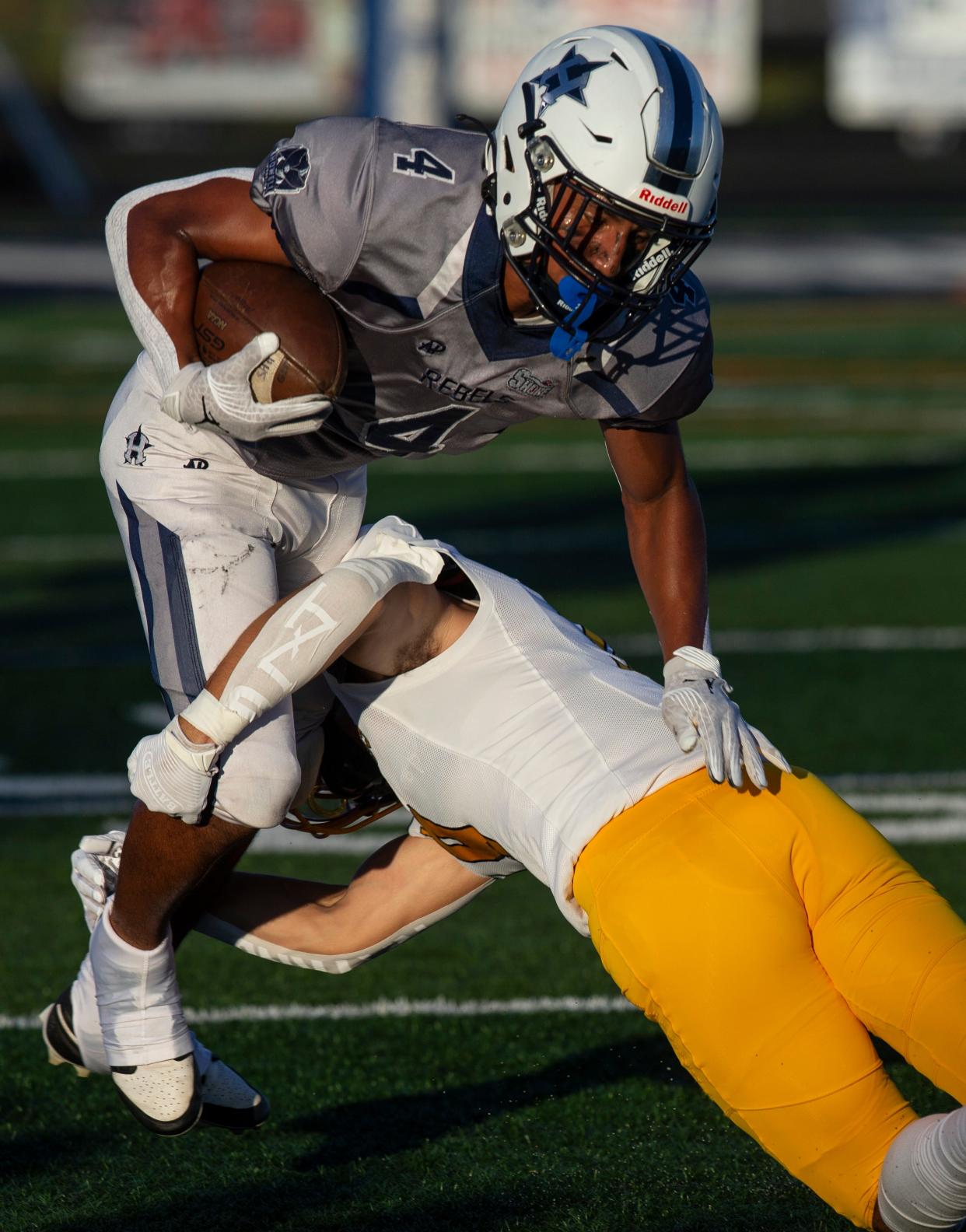 Howell’s Zach Padilla gains yards jumping over Marlboro’s Nicholas Scaff. Marlboro vs Howell football.  
Howell, NJ
Thursday, September 14, 2023