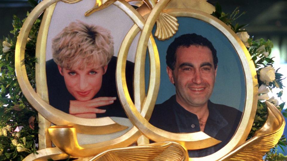 princess diana and dodi fayed memorial at harrods includes framed photos of both in front of white roses and other floral greenery