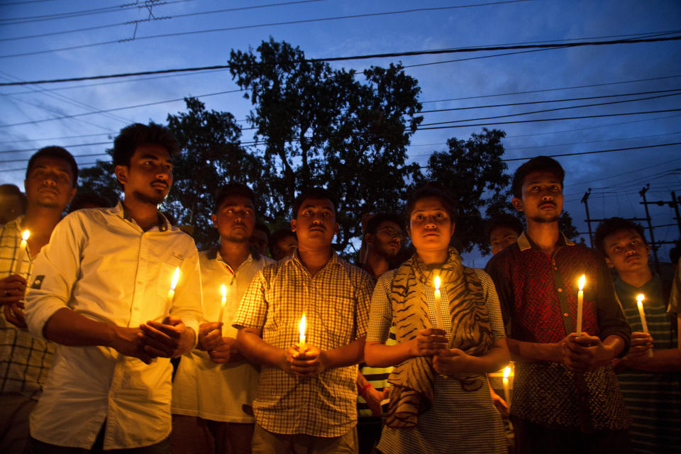 In this Monday, June 11, 2018 photo, supporters of Nilotpal Das, and Abhijit Nath, who were killed by mobs, hold candles during a protest in Gauhati, India. Fueled by rumors of child kidnappers, and spread on social media, mobs have killed well over a dozen Indians in brutal attacks since early May. (AP Photo/Anupam Nath)